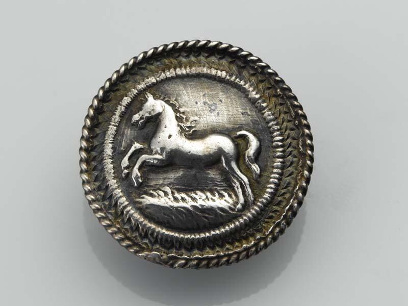 Platte, ronde knoop met een opspringend paard