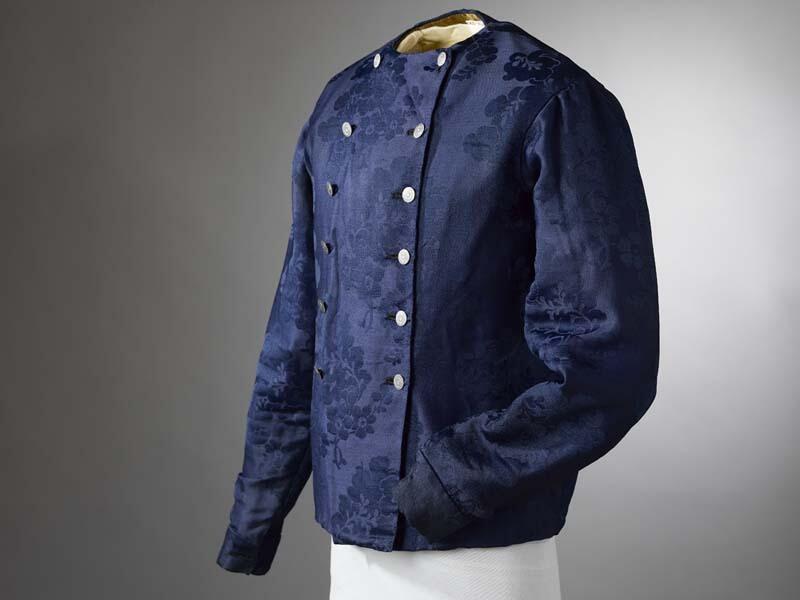 Baeitje of mannenvest van donkerblauwe damast (wol) met ingeweven bloempatroon dat ook donkerblauw…