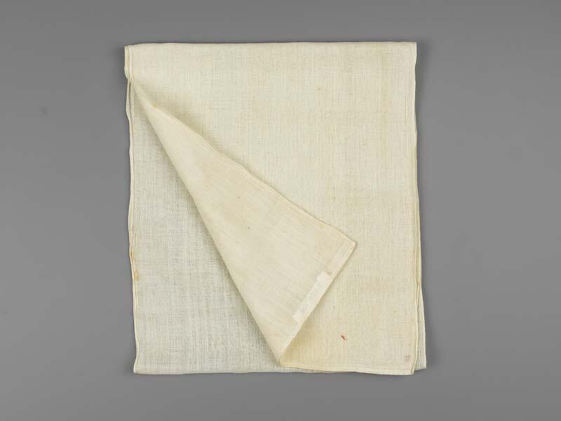 Een langwerpig sjaal van neteldoek, initialen G.I.