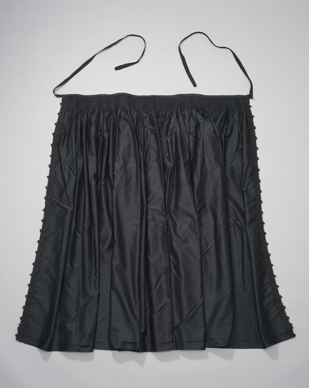 'Spelerijders' schort, Walcheren, voor 1957