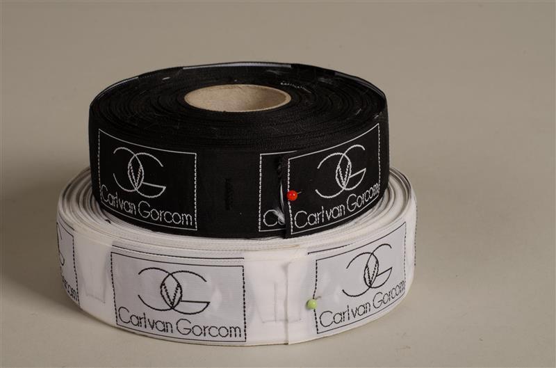 Twee rollen labels behorend bij kleding Carl van Gorcom