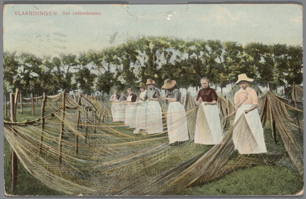 Vrouwen in Vlaardingse streekdracht aan het netten boeten.
