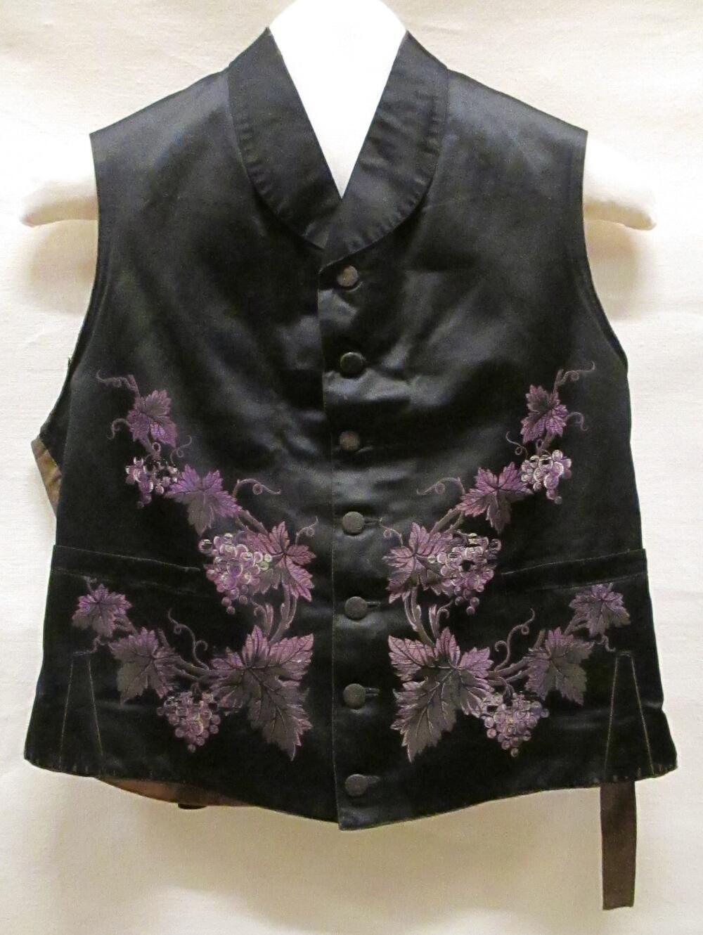 Vest (man) van zwart satijn met een garnering van ingeweven paarse, witte en bruine florale…