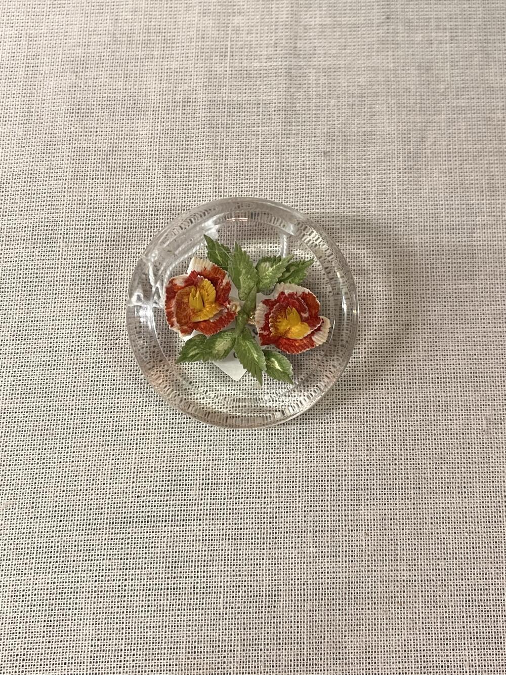 Broche met bloemen, gegoten kunststof, cirkel-vormig, doorzichtig met rode bloemen en groene…