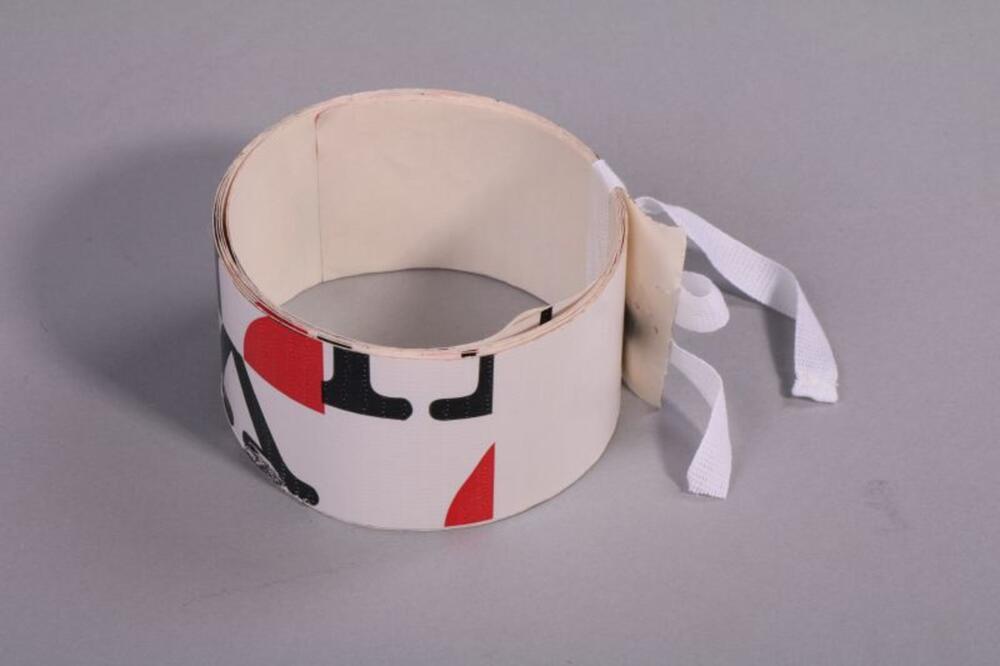 Brede riem van witte tape met een print in rood en zwart
