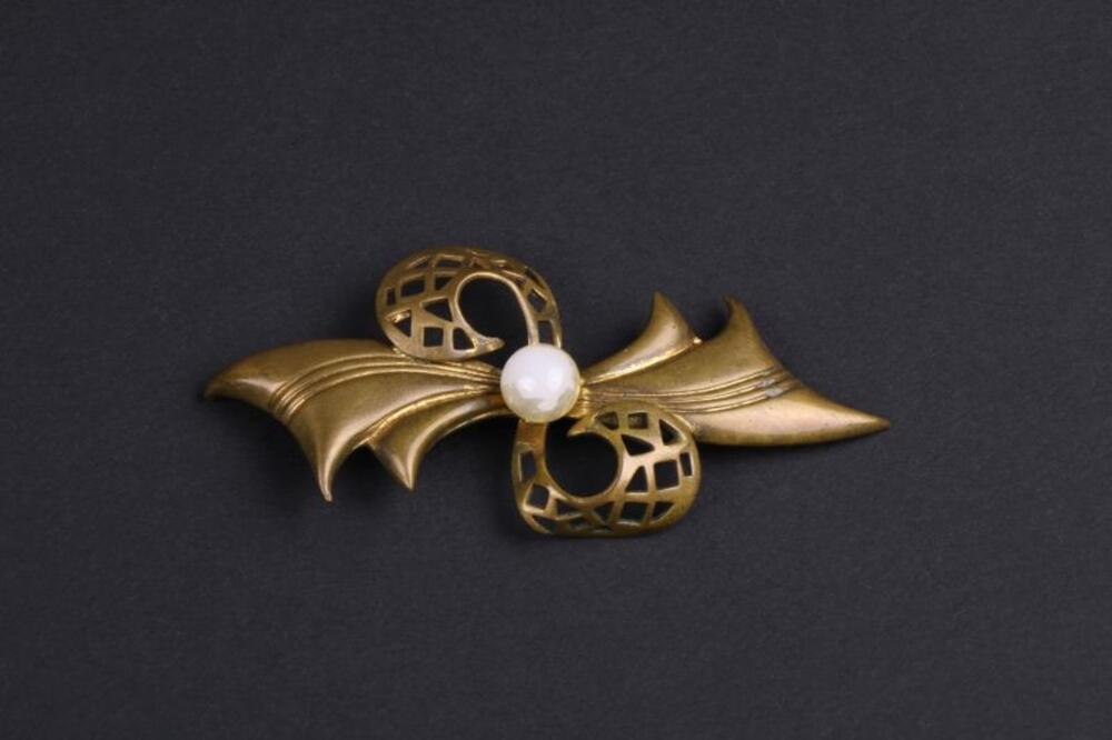 Broche in koperkleurig metaal