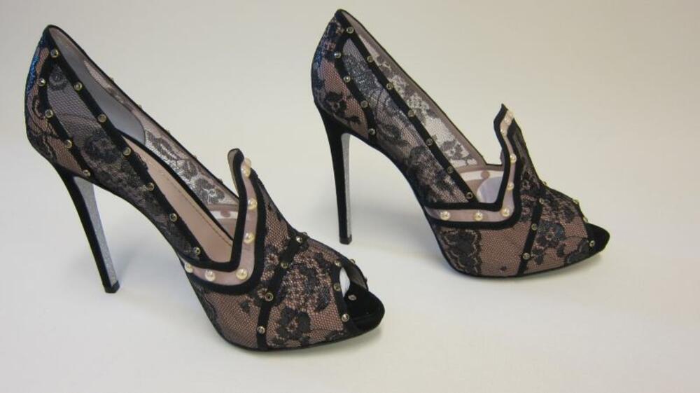 Hoge zwarte pumps met kant, stras en parelversiering en een zilverkleurige zool