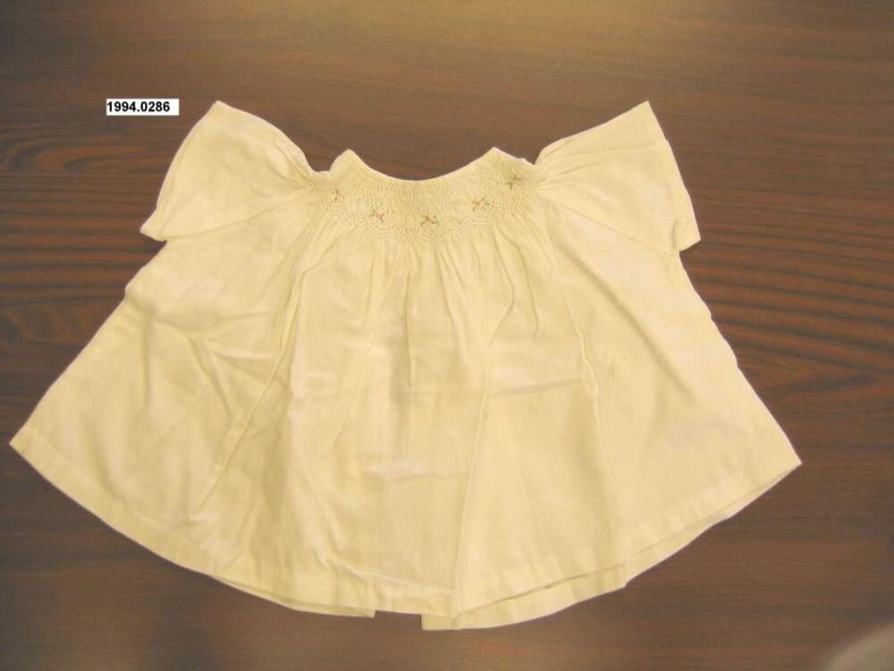 Blouse in witte katoen met smok rond de hals