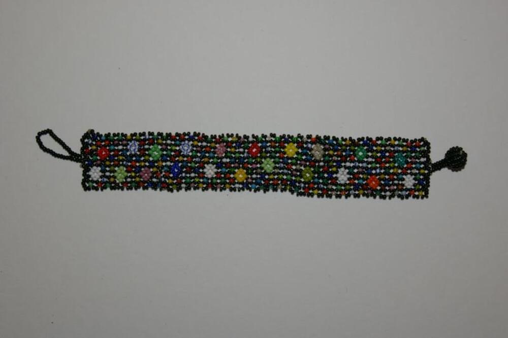 Armband van veelkleurige, kleine plastic kralen in bloemenmotief
