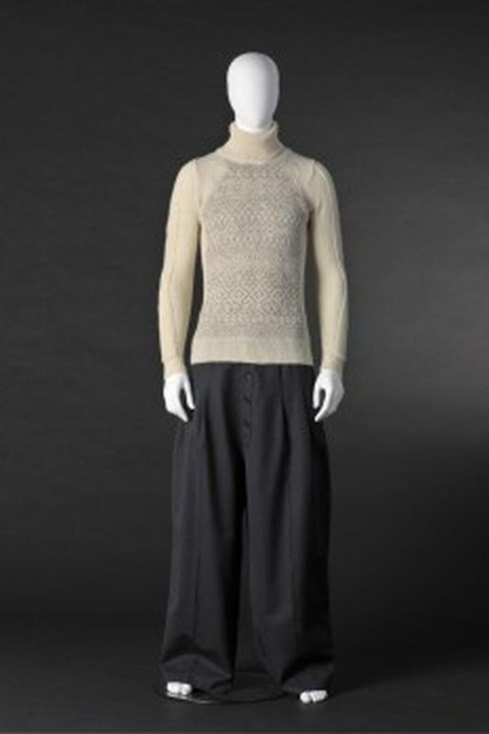 Ensemble bestaande uit zwarte, brede broek en ecru rolkraagtrui met grijze, ingebreide tekening