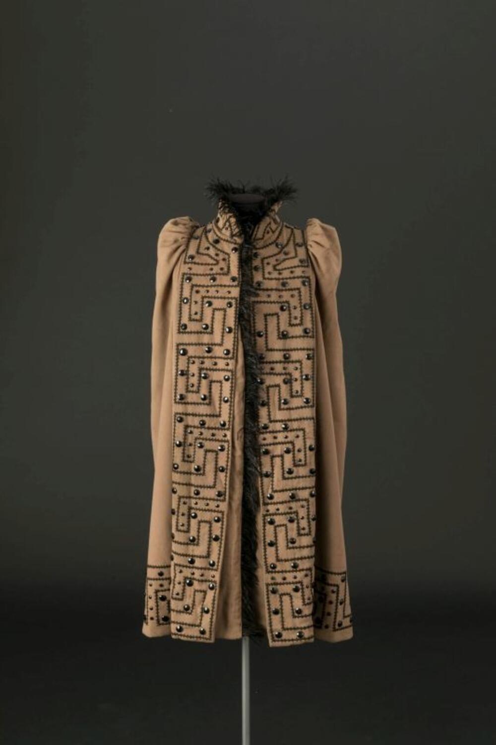 Cape in bruine wol versierd met zwart lint en stenen