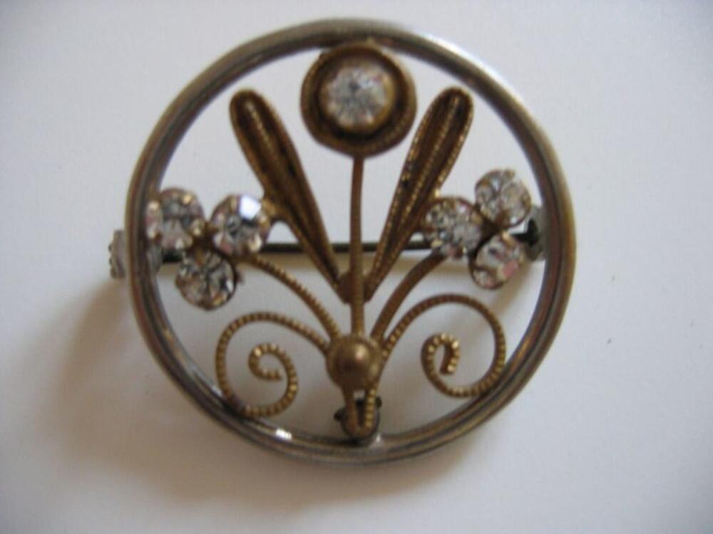 Broche in koperkleur met bloemversiering