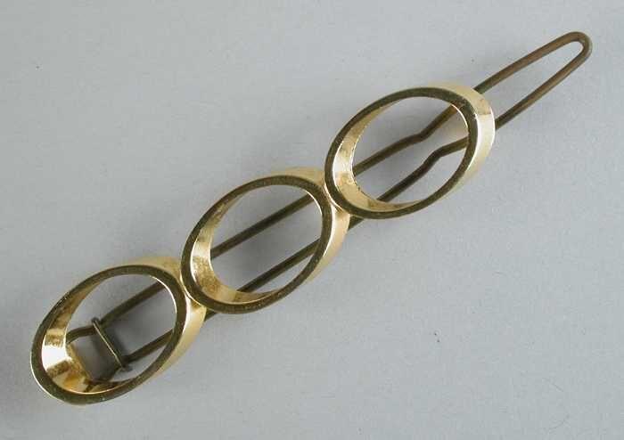 haarschuif, drie goudkleurige opengewerkte ovale metalen ringen, met metalen clip