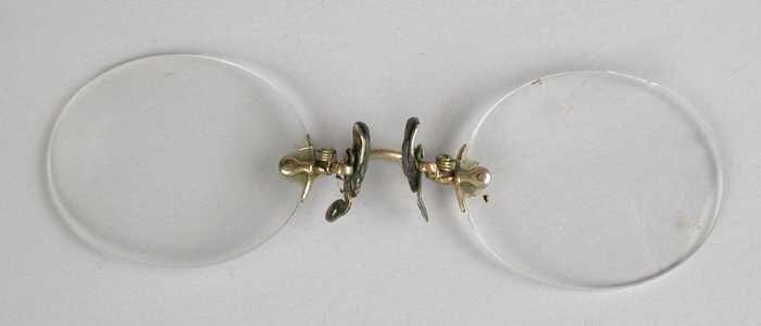 Knijpbril of pince-nez zonder montuur, met ovale glazen op sterkte, goudkleurige brug en flexibele…