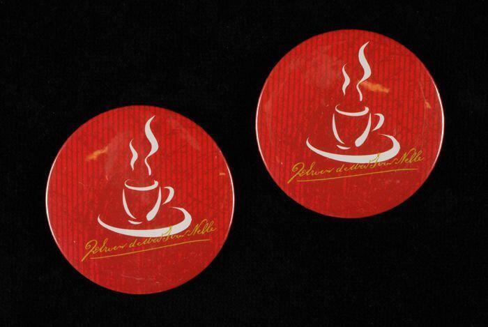 Twee rode buttons van Van Nelle met gestileerde kop koffie