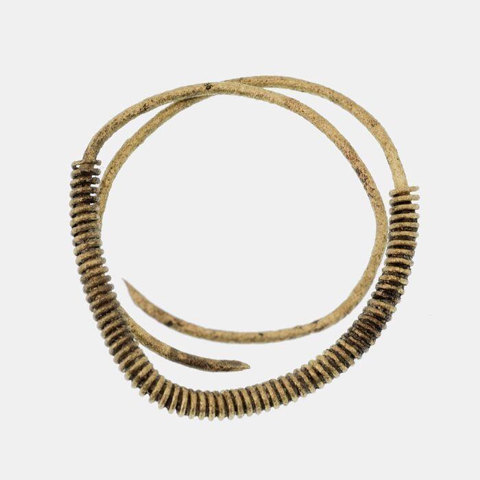 Messing ring met meerdere windingen, deels omwonden met koperdraad
