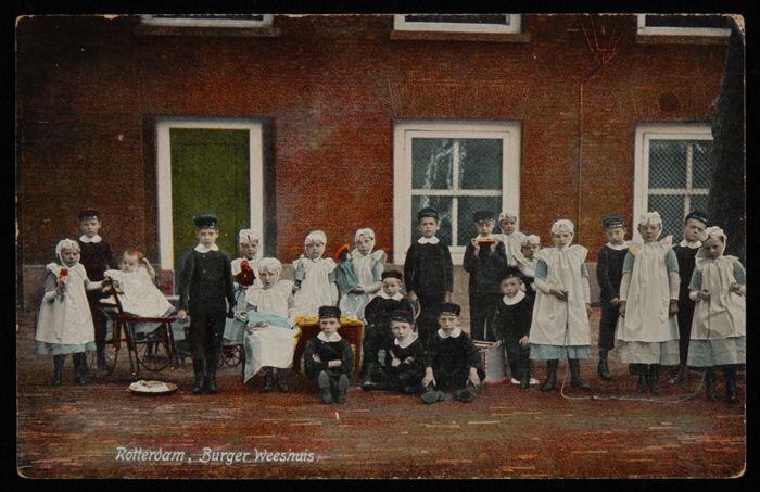 Gekleurde prentbriefkaart, groep kleine wezen op de binnenplaats van het Gereformeerd Burger…