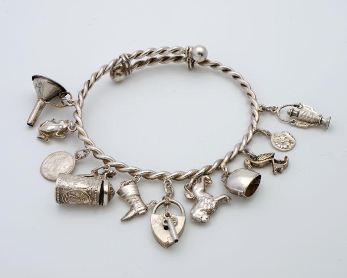 Bedelarmband van gedraaide zilveren schakels met elf bedels