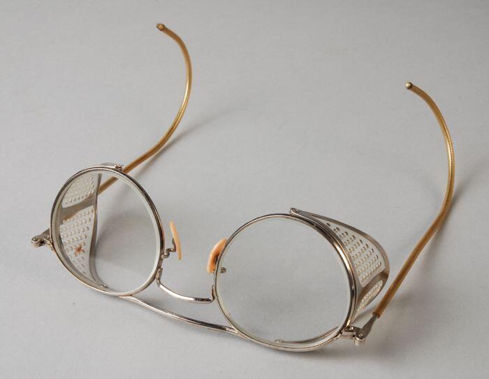 Veiligheidsbril met blank metalen montuur, ronde glazen zonder sterkte, kunststofzijkleppen en…