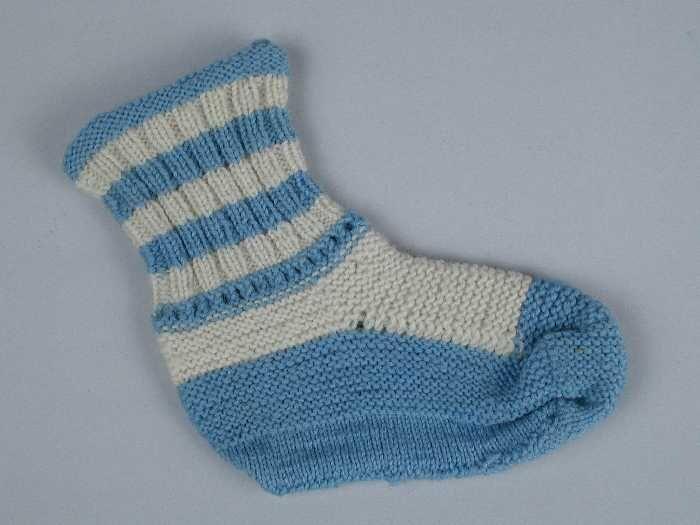 Paar babysokken gebreid van blauwe en witte wol in tricot- en ribbelsteek, ajourrand rond de enkel