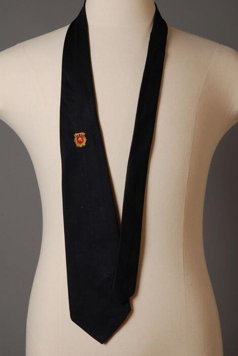 Stropdas van donkerblauw zijde met ingeweven brandweerembleem