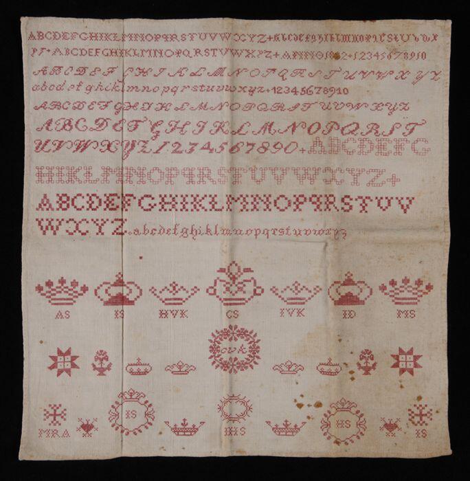 Letterlap gewerkt in kruissteek in rood katoenop zeer fijn crèmekleurig katoen "ANNO 1852", oefening