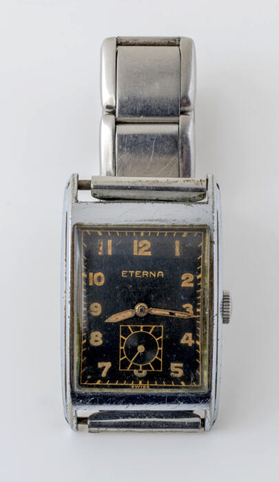 Rechthoekig herenhorloge van edelstaal met donkere rekbare schakelarmband, merk "Eterna"