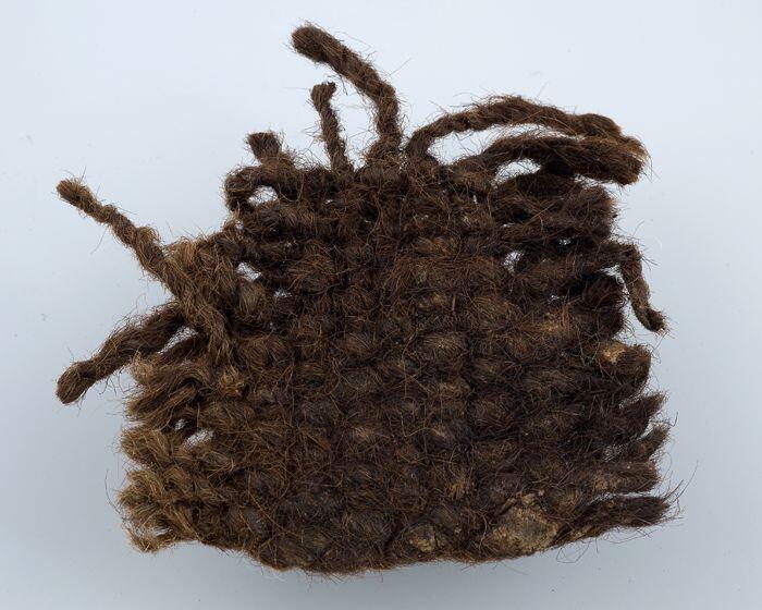 Fragment wollen stof of kleding, bruin gekleurd