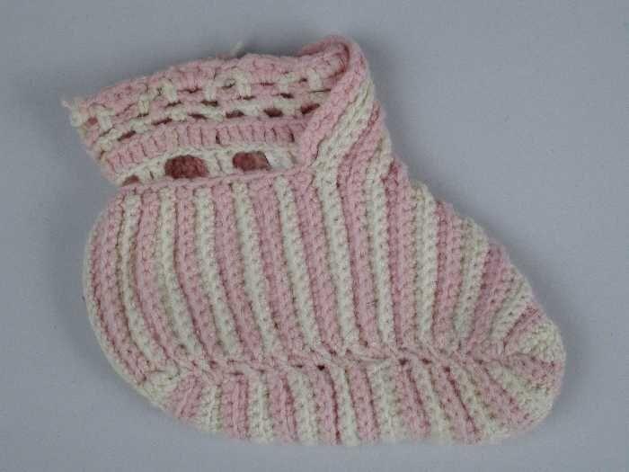 Paar babysloffen gehaakt vanafwisselend witte en roze wol ajourrand bij de enkel