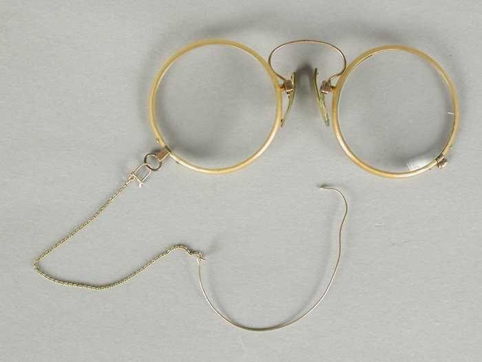 Pince-nez of knijpbril met ronde glazen op sterkte en een montuur van geel celluloid