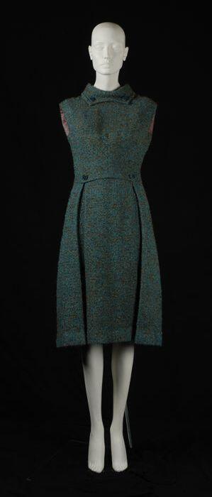 Mouwloze japon van zeegroene bouclé wol kuitlang rokdeel met diepe plooien, "Lara Couture"