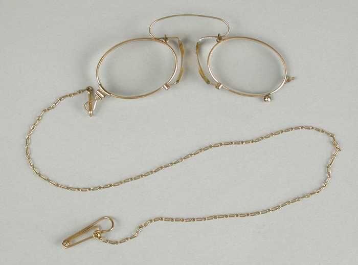 Knijpbril of pince-nez met ovale glazen op sterkte, montuur van verguld koper, hoge brug en…