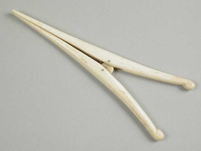 Handschoenrekker van been, twee spits toelopende poten met korte veer