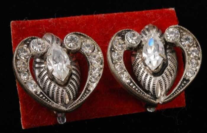 Eén paar oorbellen, clip met kleine kunstdiamantjes in hartvormige zilverkleurige metalen zettin,…