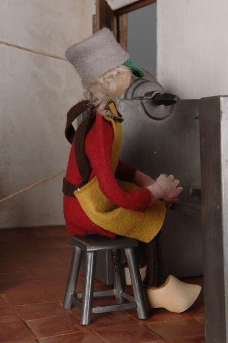 Pop van tinegieter, zittend aan het werk, behorend bij model van interieur Oudhollandse…
