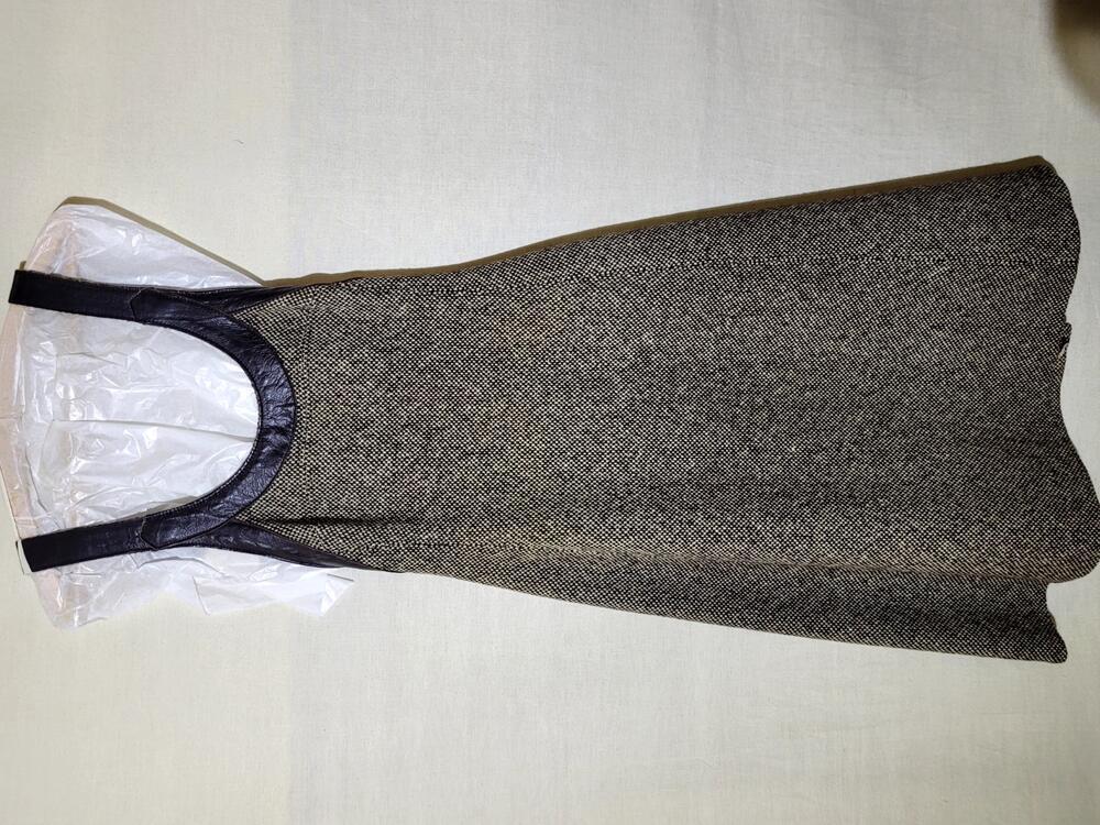 Overgooier van bruin/witte wollen tweed met bruine lederen schouderbanden, drukknoopsluiting…