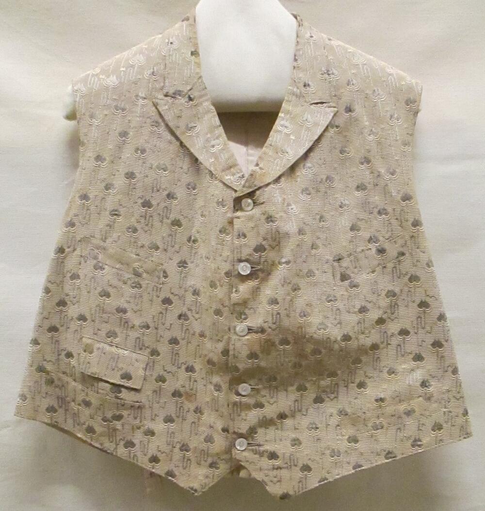 Vest (man) van beige gebrocheerde ripszijde met grijze figuurtjes, achterpand en voering van witte…