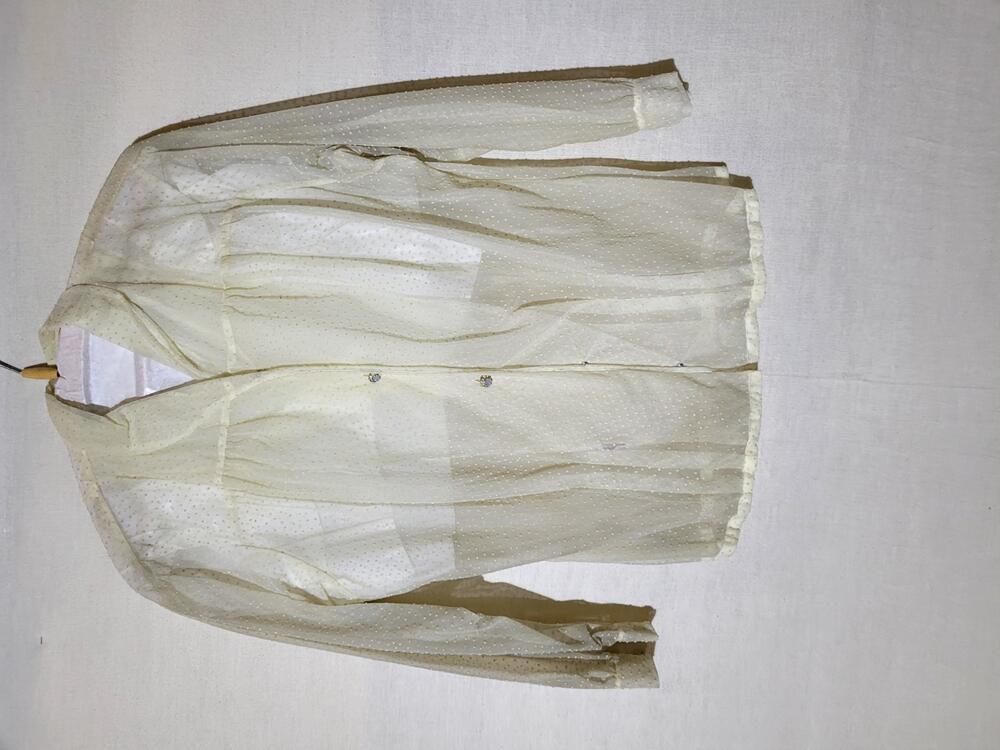 Blouse van wit doorschijnend nylon met ingeweven nopjespatroon