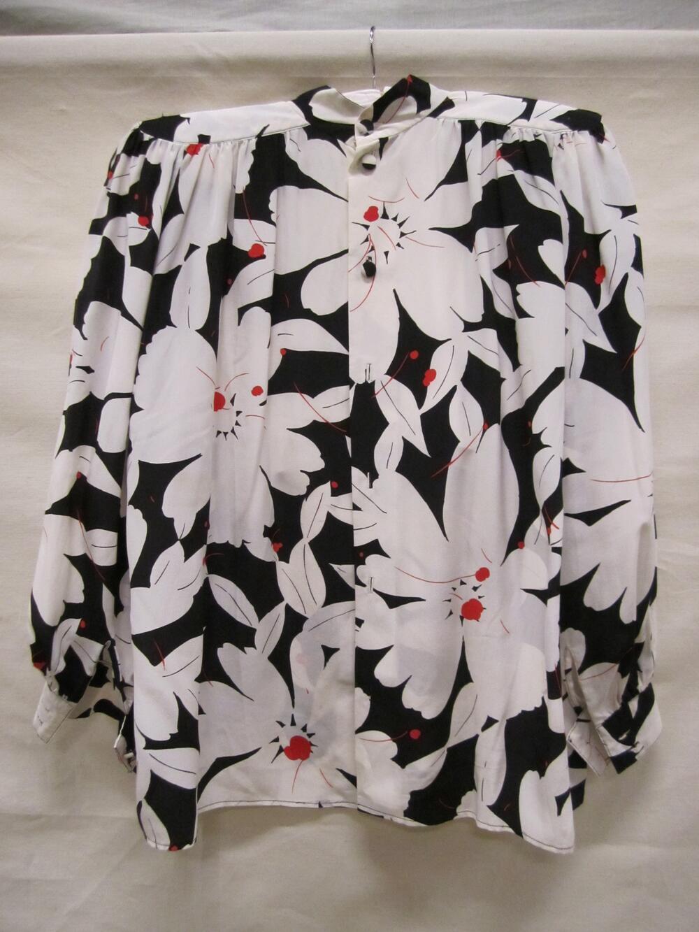 Blouse van witte crêpe zijde bedrukt met bloemmotief in zwart en rood
