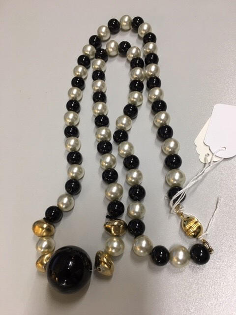 Ketting. Plastic imitatie parels. Zwarte en witte parels. In het midden een grote zwarte parel/…