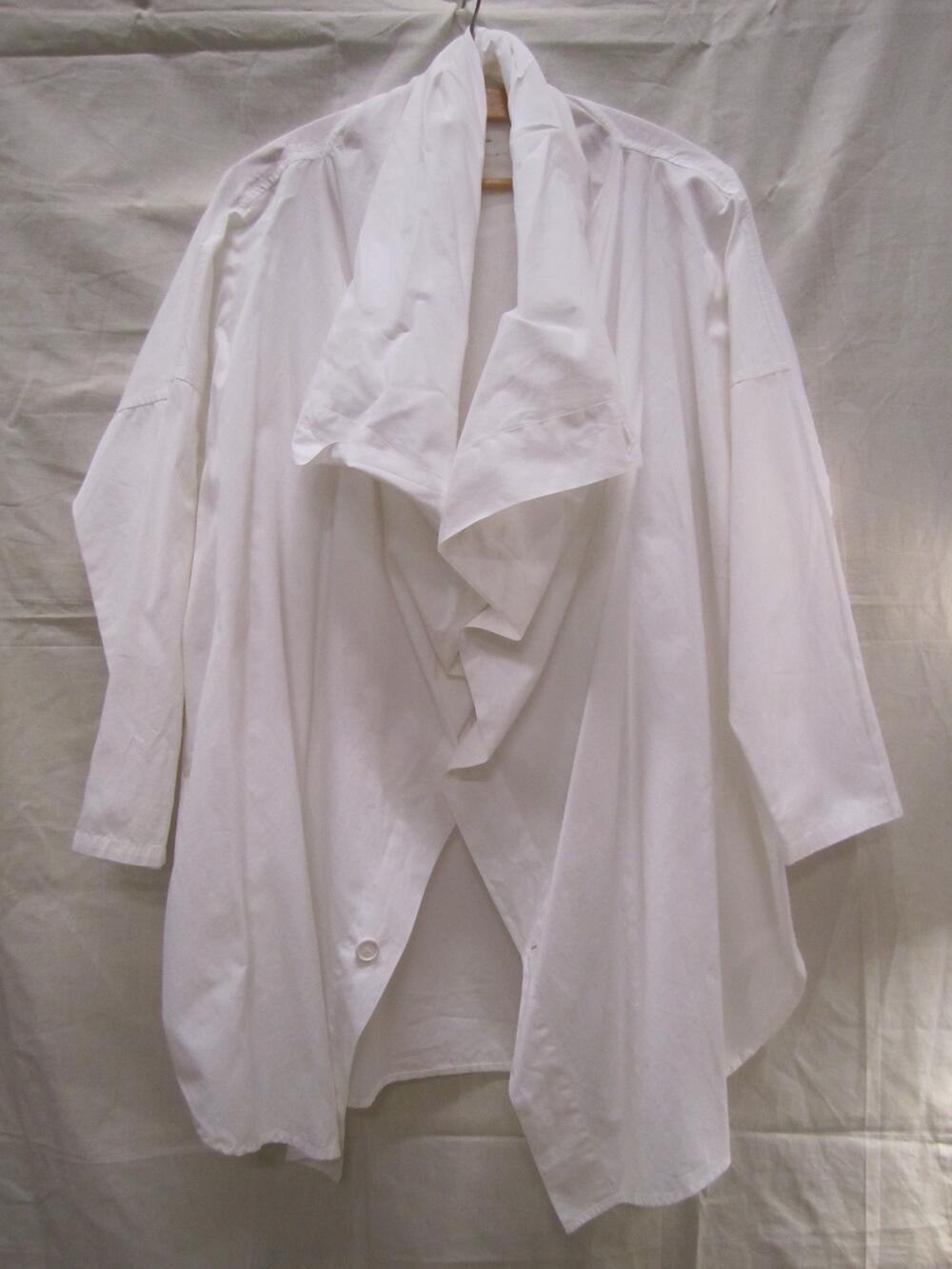 Blouse van wit katoen, zeer wijd model met lange mouw en voorpanden doorlopend in de colvormige,…