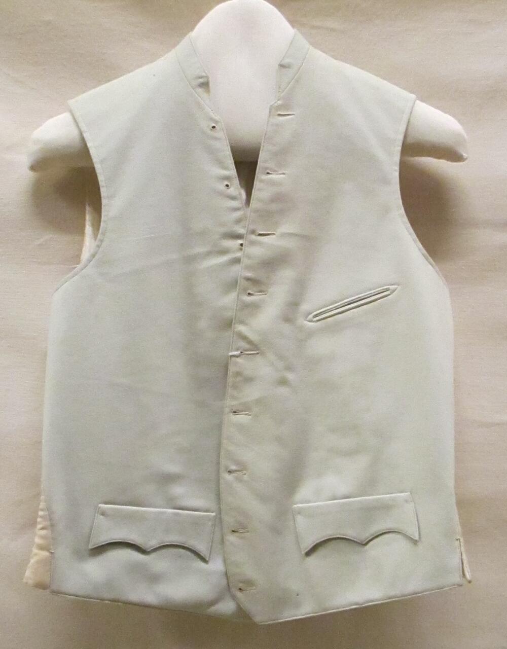 Vest (man) van grijs laken met een achterpand van cremekleurige stof in keperbinding