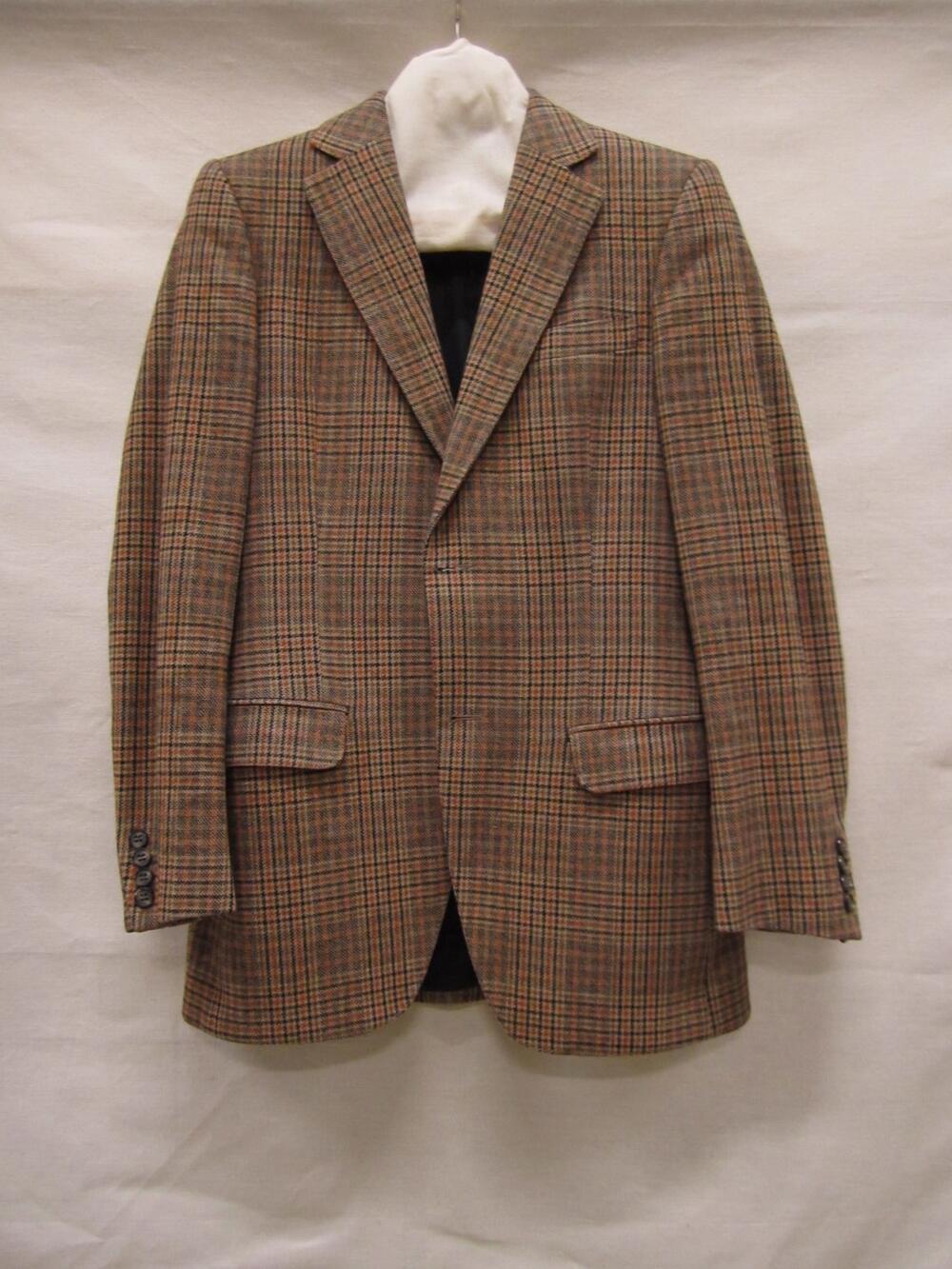 Jasje van geruite wol in zwart, beige, bruin en roodbruin pied-de-poule. Getailleerd model met…