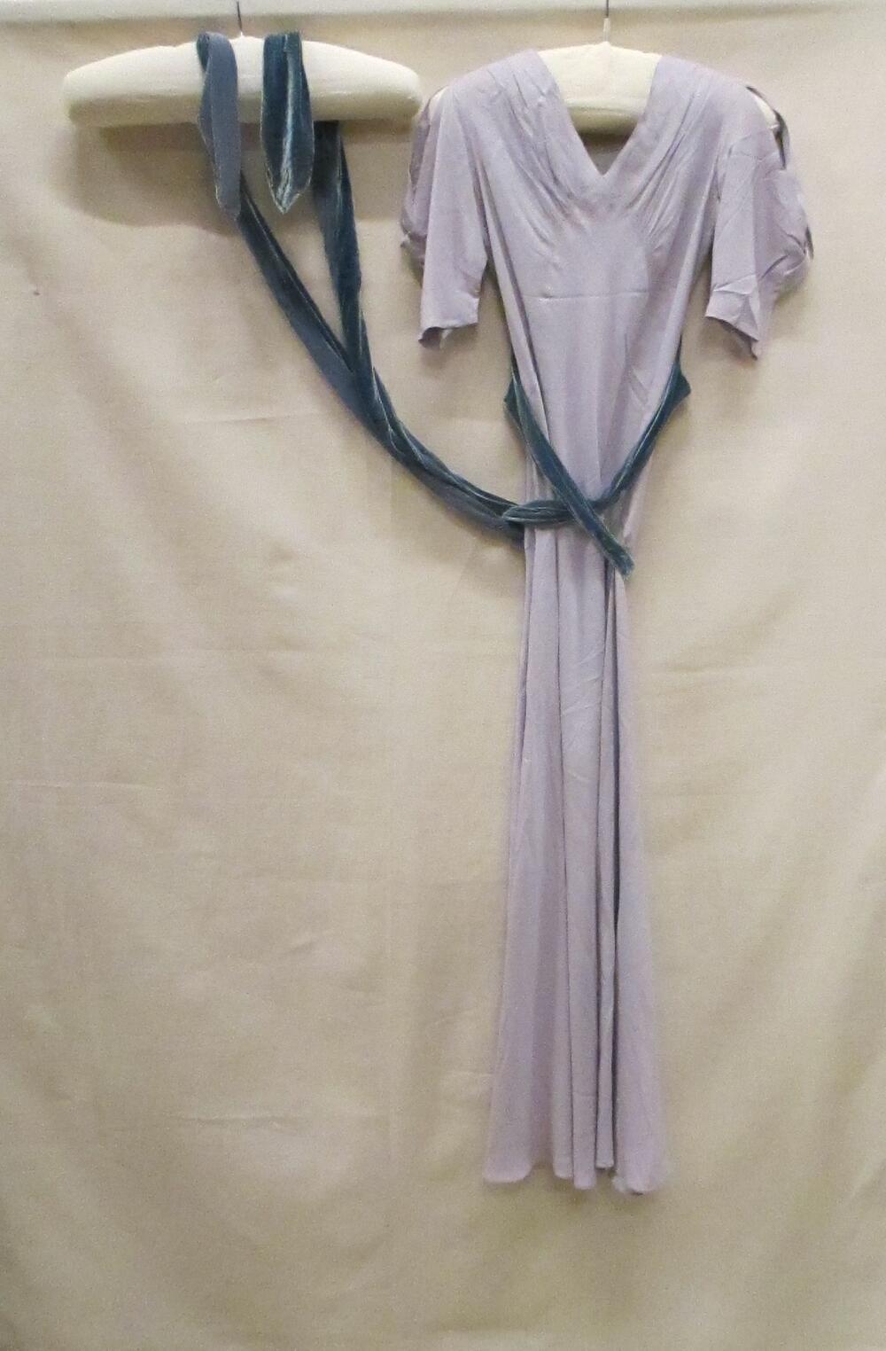 Avondjurk van lichtpaarse zijde met te kruisen ceintuur van blauw velours chiffon