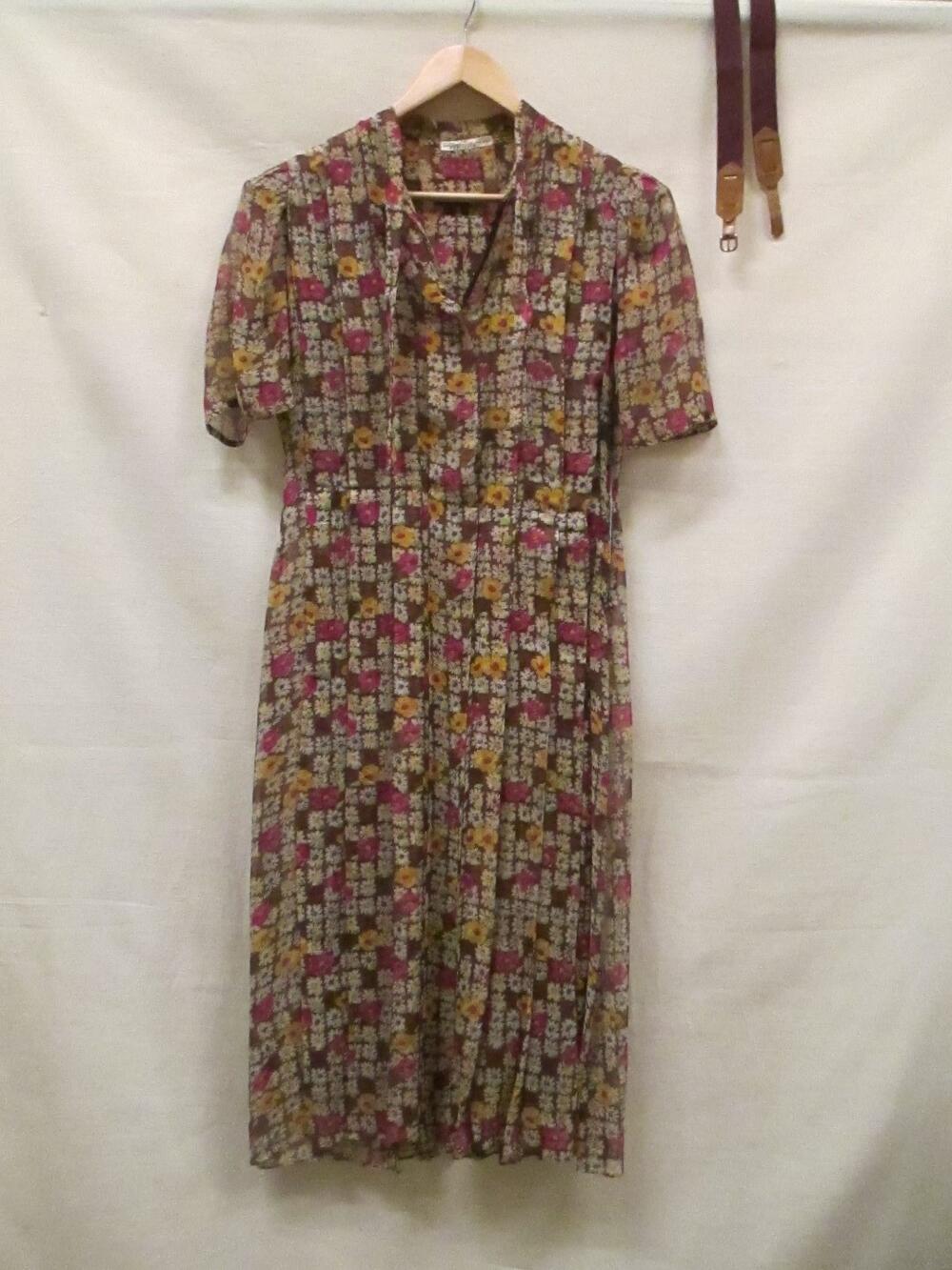 Jurk van crêpe georgette, bedrukt met bloemetjes in diverse kleuren op bruin fond. Ceintuur van…