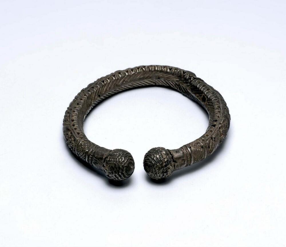 Wit metalen armband, versierd met geciseleerde motieven