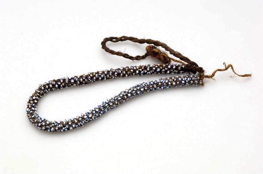 Necklace of plaited fibers with beads