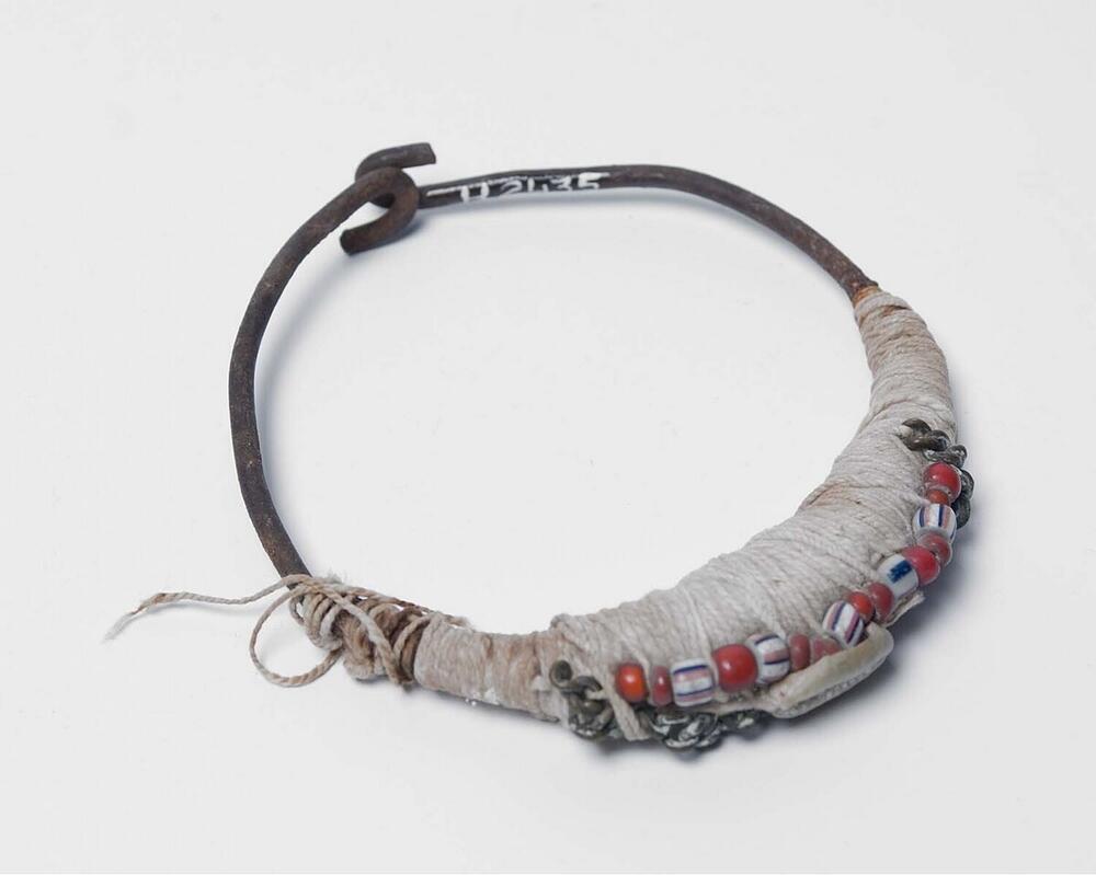 Bovenarmring met witte klei en kaurischelpen
