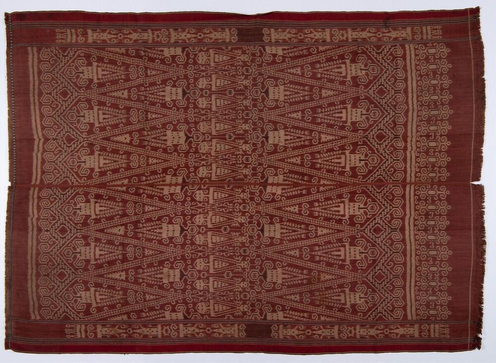 Katoenen doek met patroon van gestyleerde figuren in schering ikat