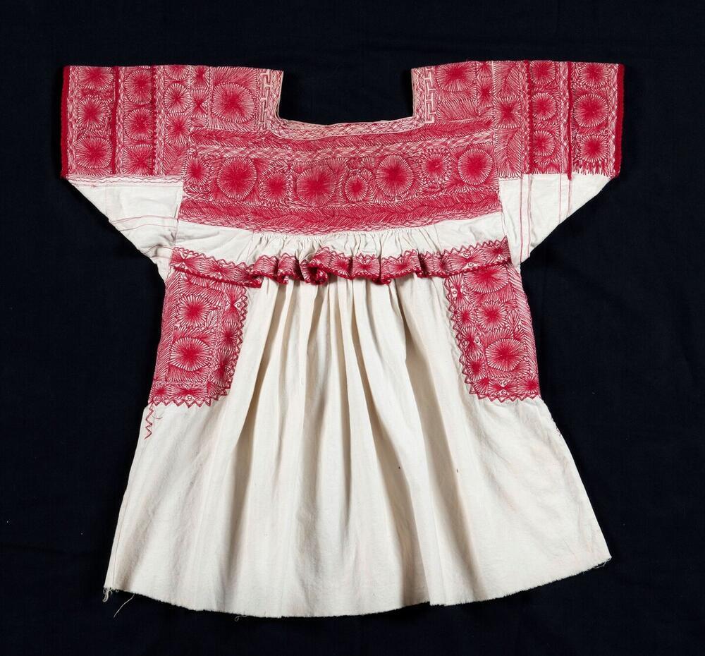 Witte blouse met rode versieringen